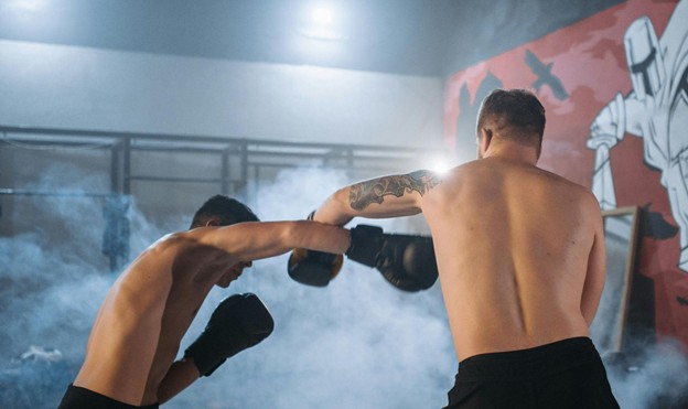 Shirtless boxers sparring.