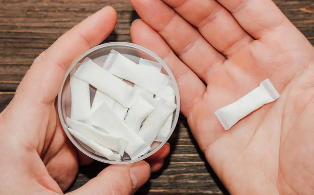 Close-up of a person holding nicotine pouches.