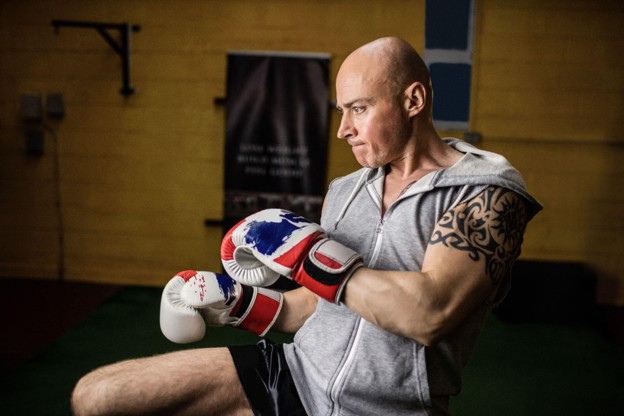 Male boxer training with gloves in a gym
